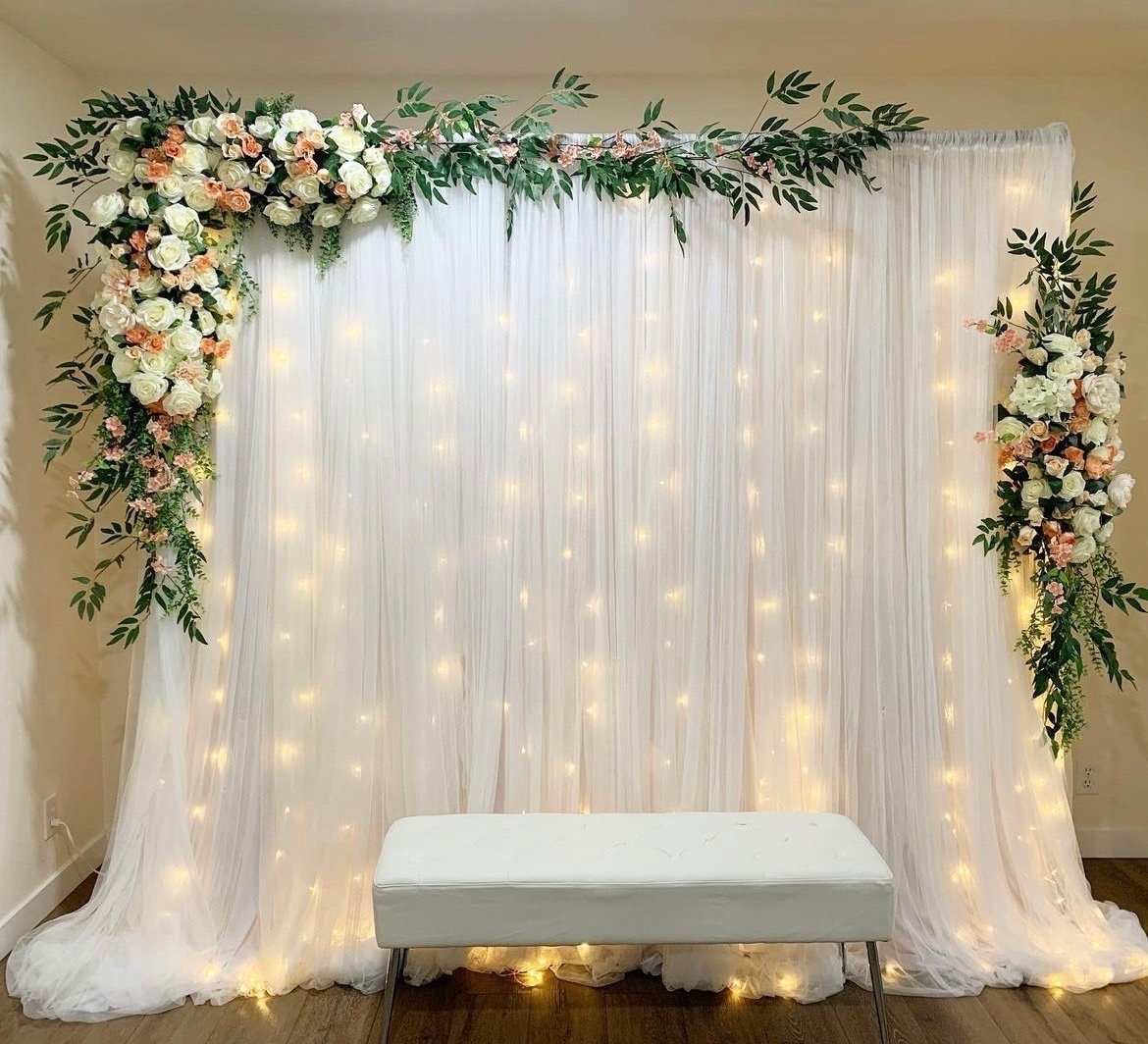 Drapery Backdrop custom structure with ivory, peach, and emerald styling for a wedding reception in the greater Seattle area