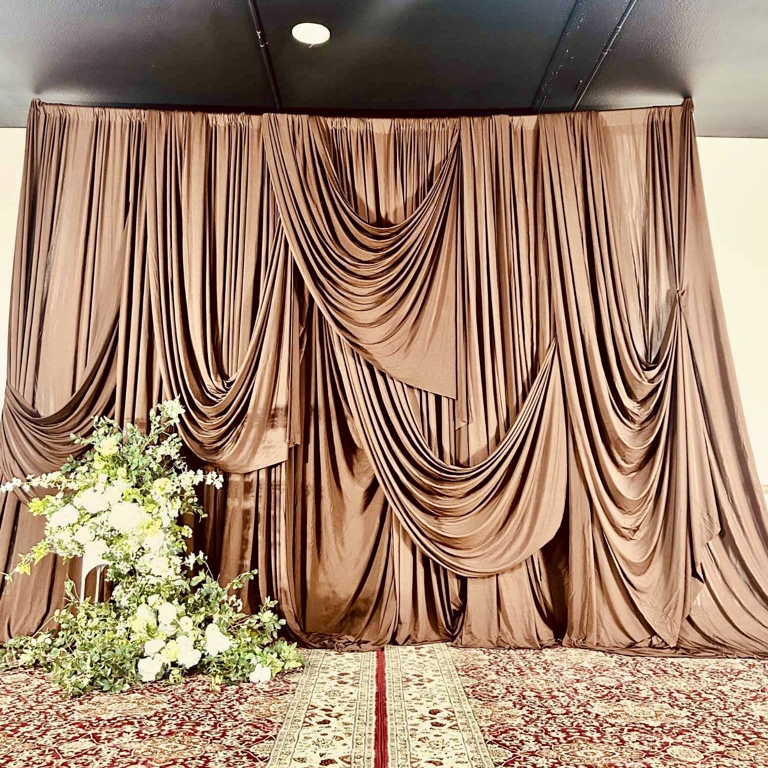 Layered Drapery Stage Backdrop custom structure with champagne, white, and emerald styling for a wedding in the greater Seattle area