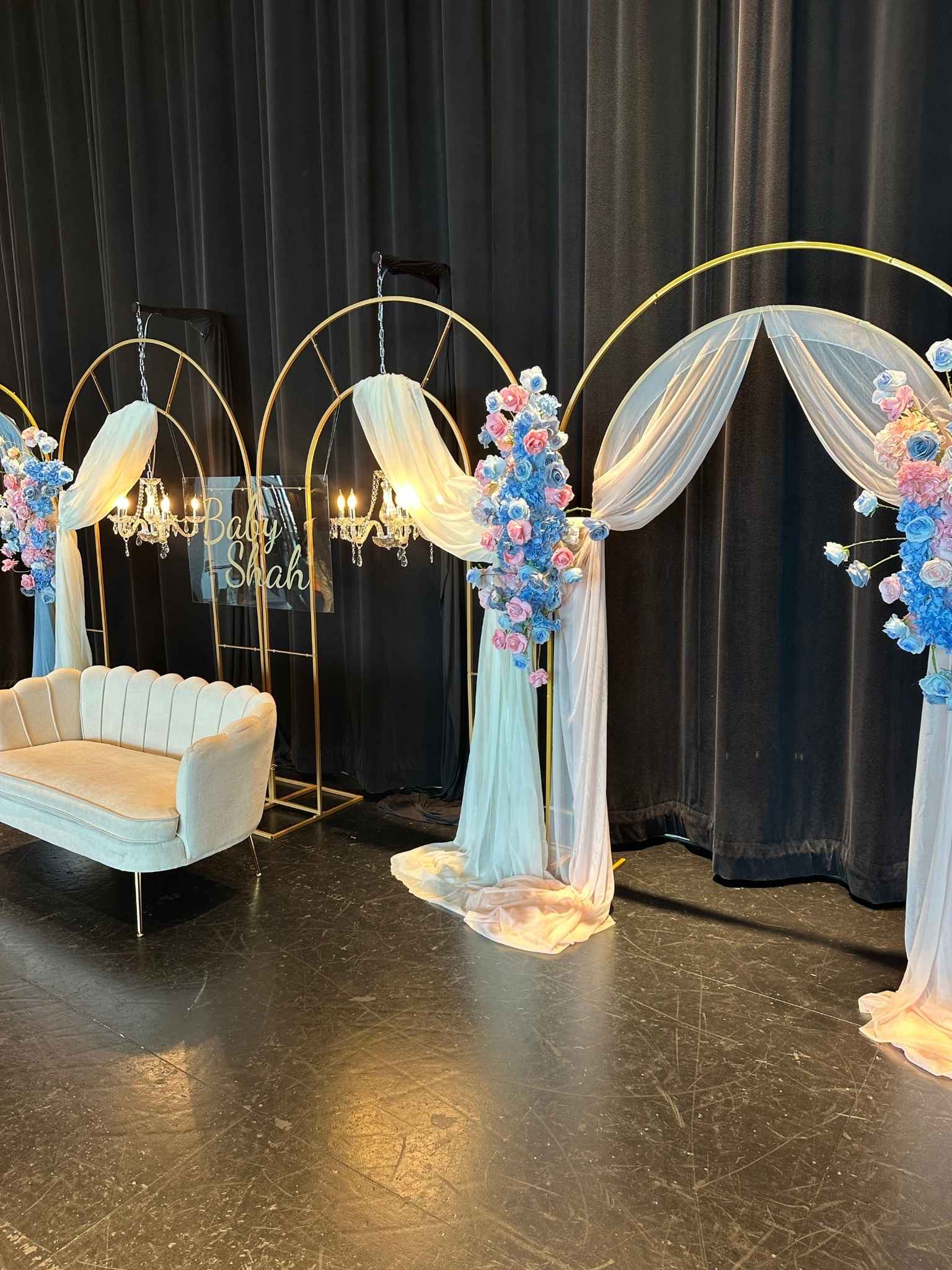 Classic Stage Backdrop custom structure with powder blue, blush, and gold styling for a gender reveal at Rosehill Community Center
