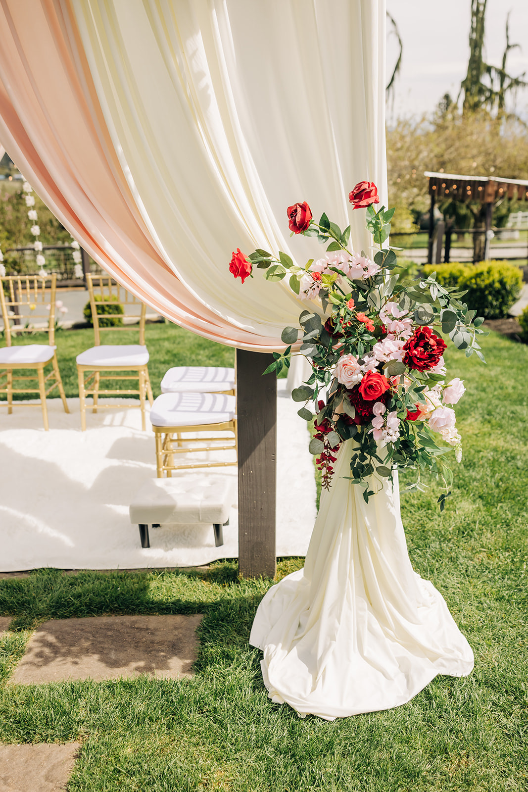 Mandap floral canopy detail with red, blush, and pink silk florals for a Hindu ceremony in the greater Seattle area