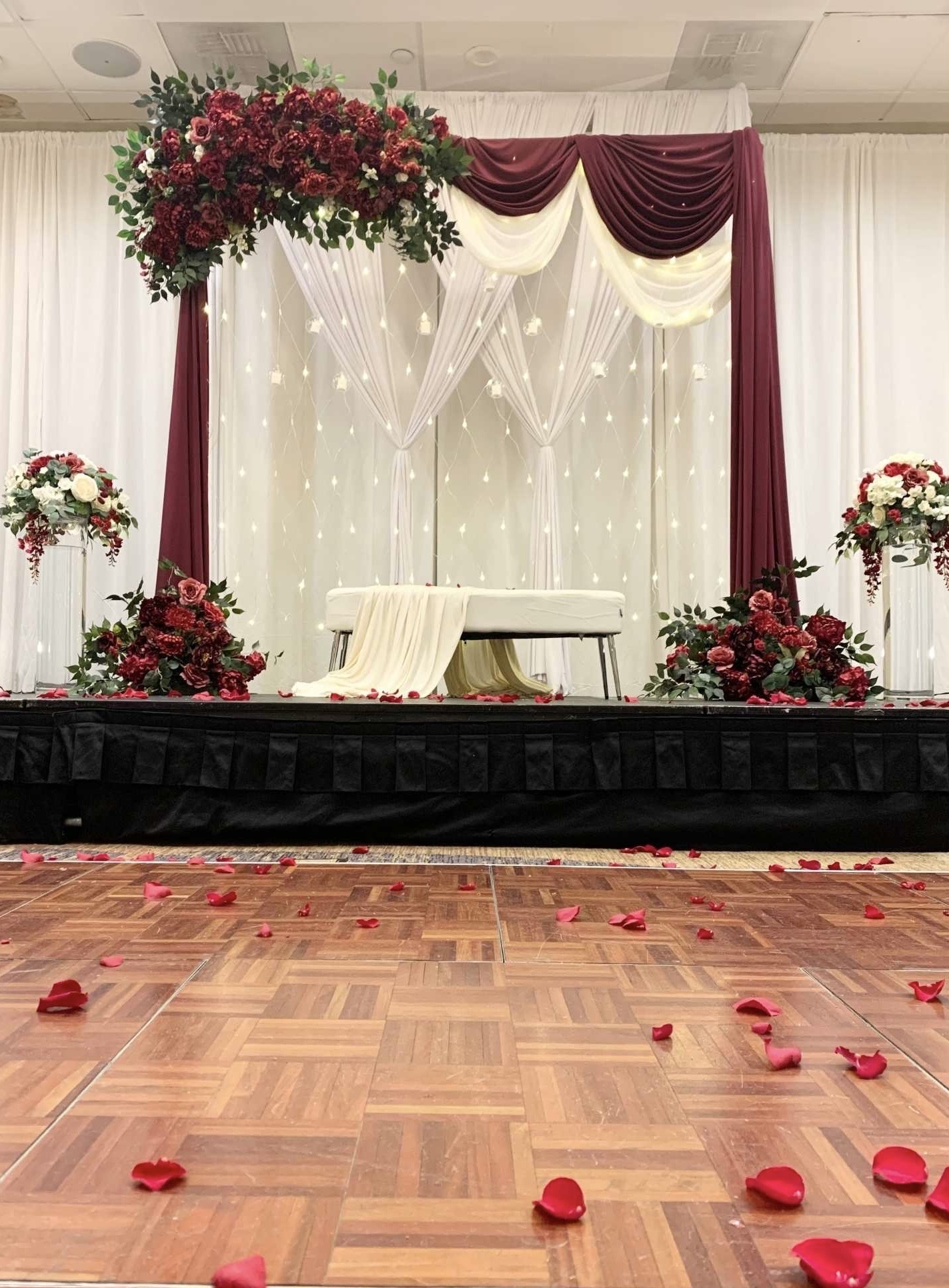 Classic Stage Backdrop custom structure with burgundy, ivory, and emerald styling for a wedding in the greater Seattle area