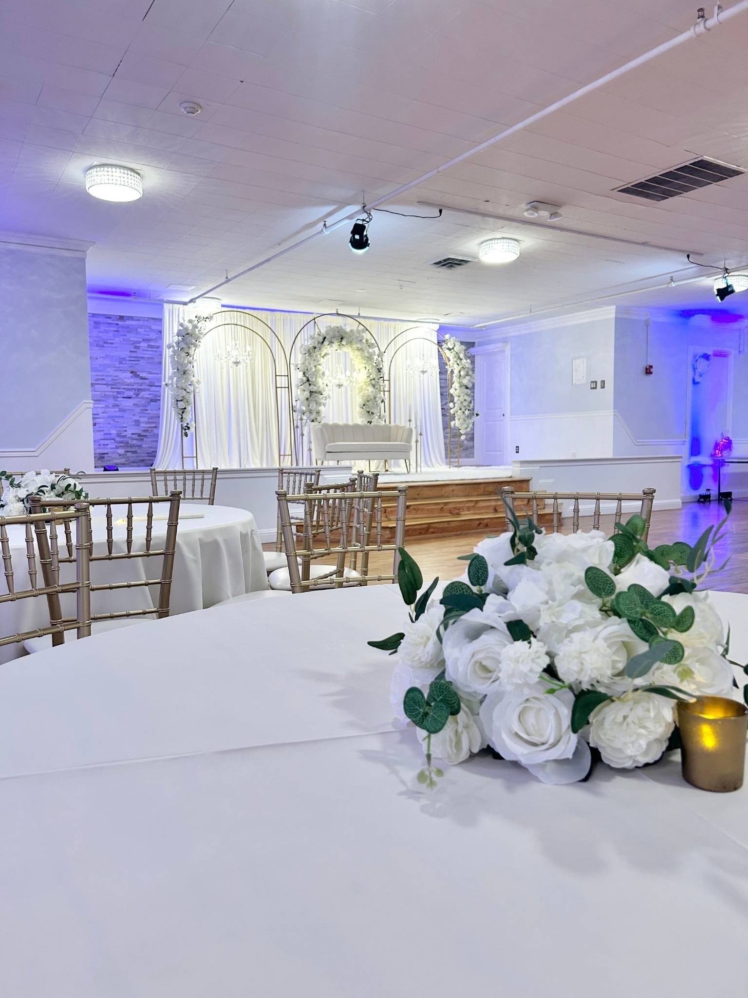 Classic Stage Backdrop custom structure with ivory, emerald, and gold styling for a wedding at Song River Banquet Center