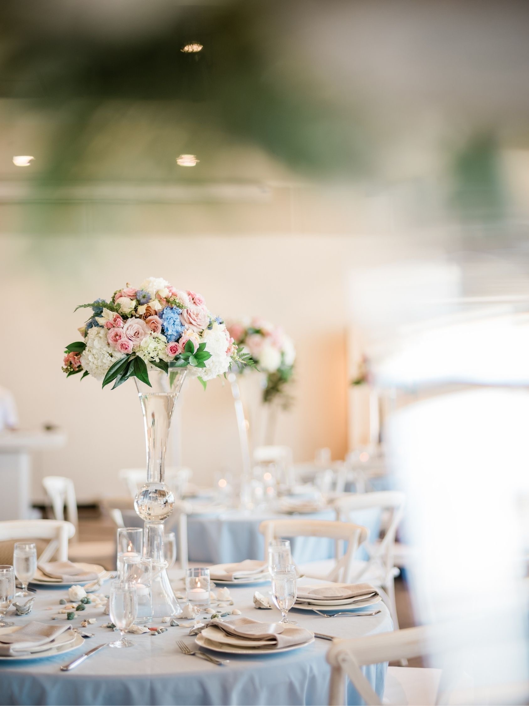 Blush, powder blue, and white floral styling and custom decor for a wedding at Song River Banquet Center