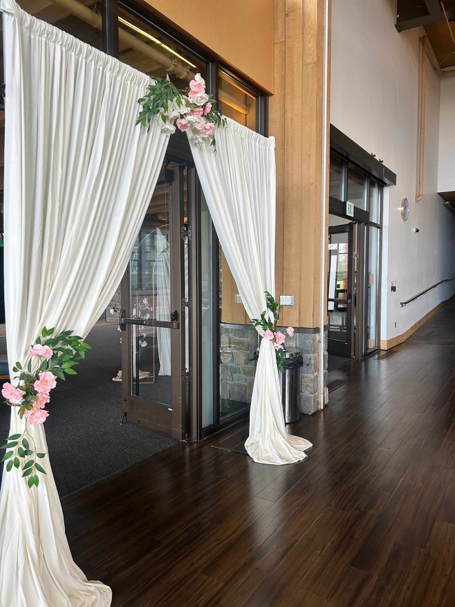 Drapery Backdrop custom structure with ivory, blush, and emerald styling for a wedding at Rosehill Community Center