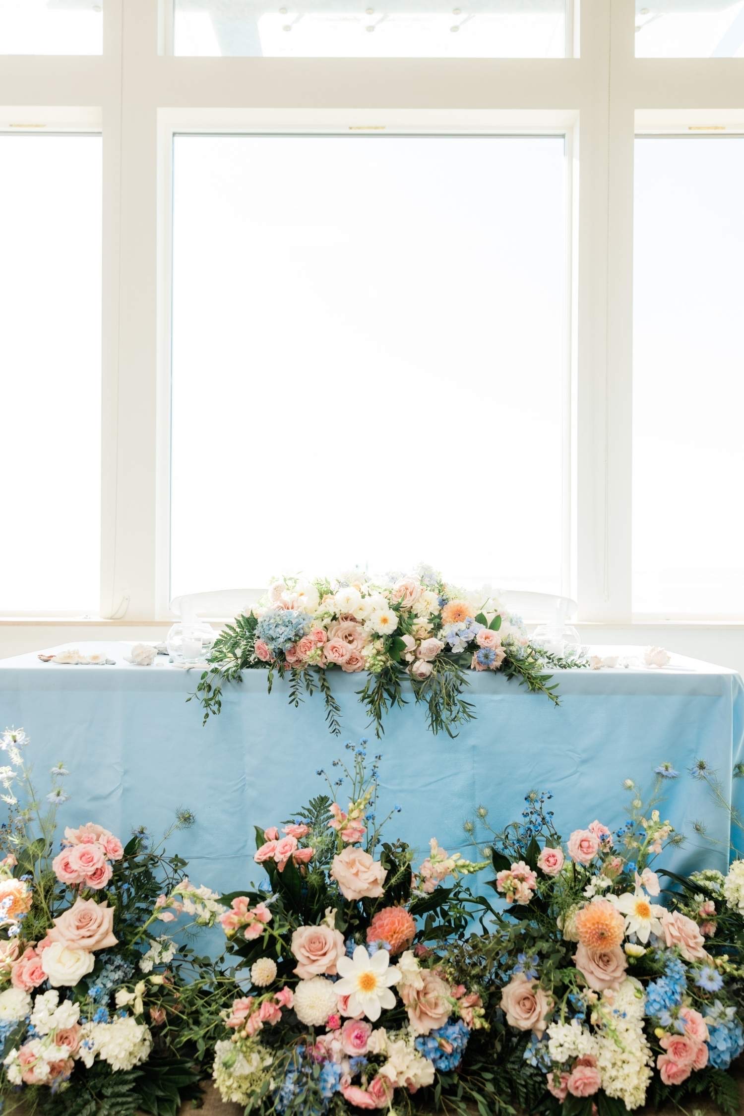 Sweetheart Table Decor custom structure with powder blue, blush, and sage styling for a wedding at Edmonds Waterfront Center