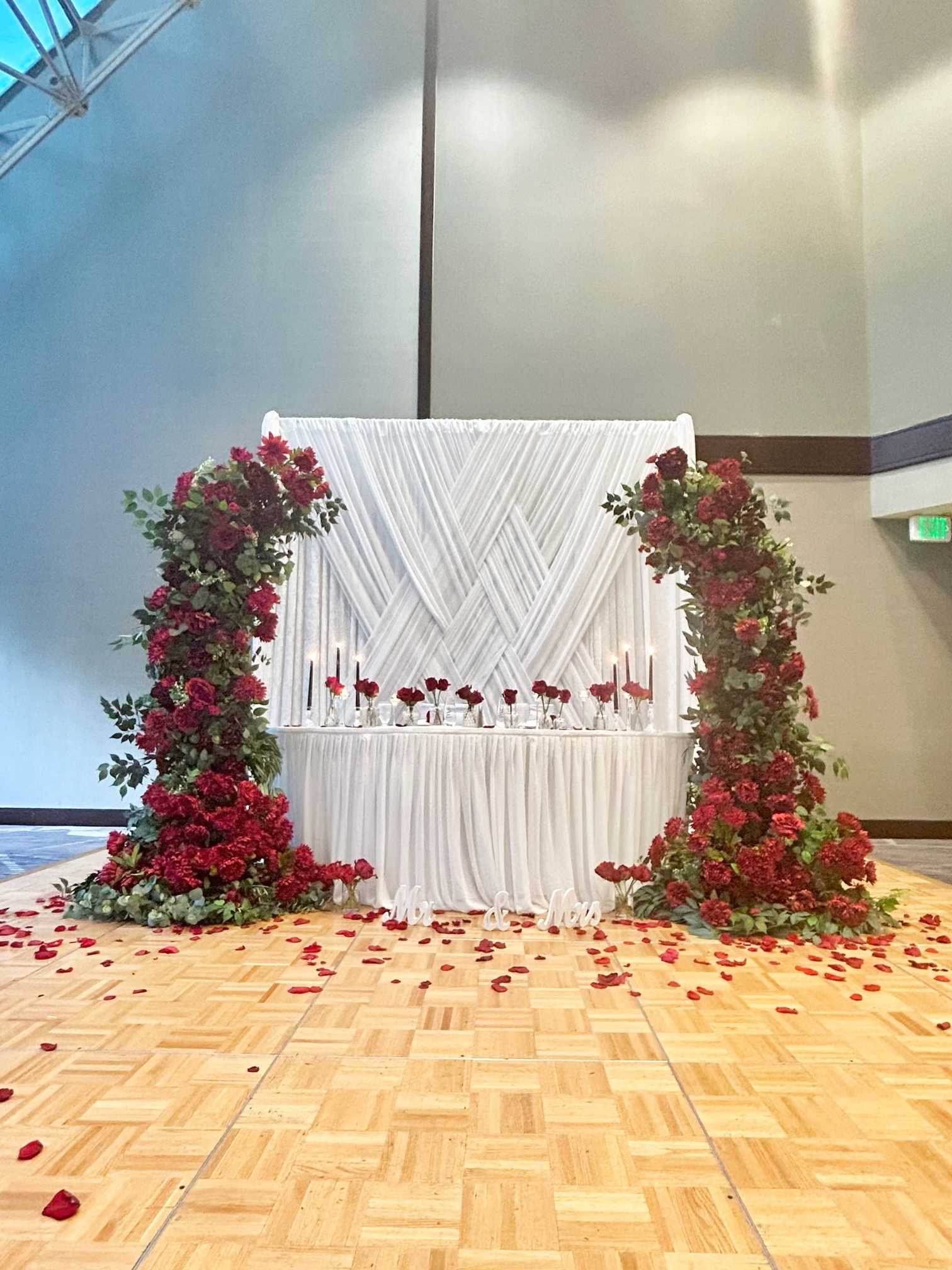 Sweetheart Table Decor custom structure with white, burgundy, and emerald styling for a wedding at Hilton Bellevue